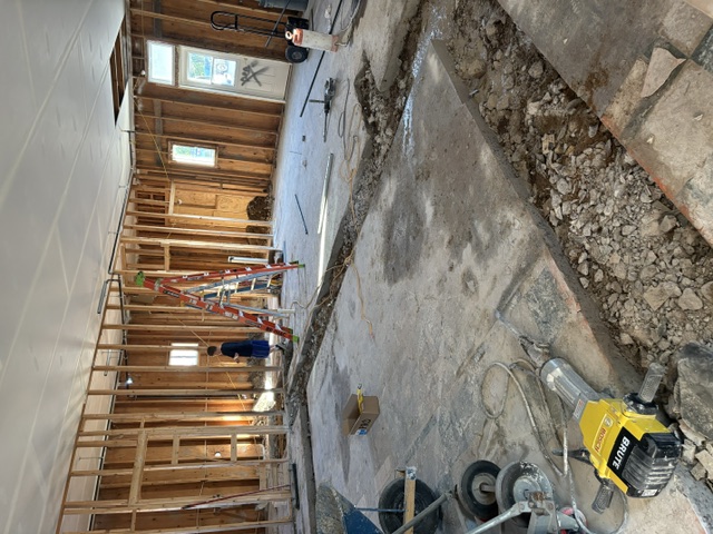 Drilling into the concrete for all of the drains and plumbing
