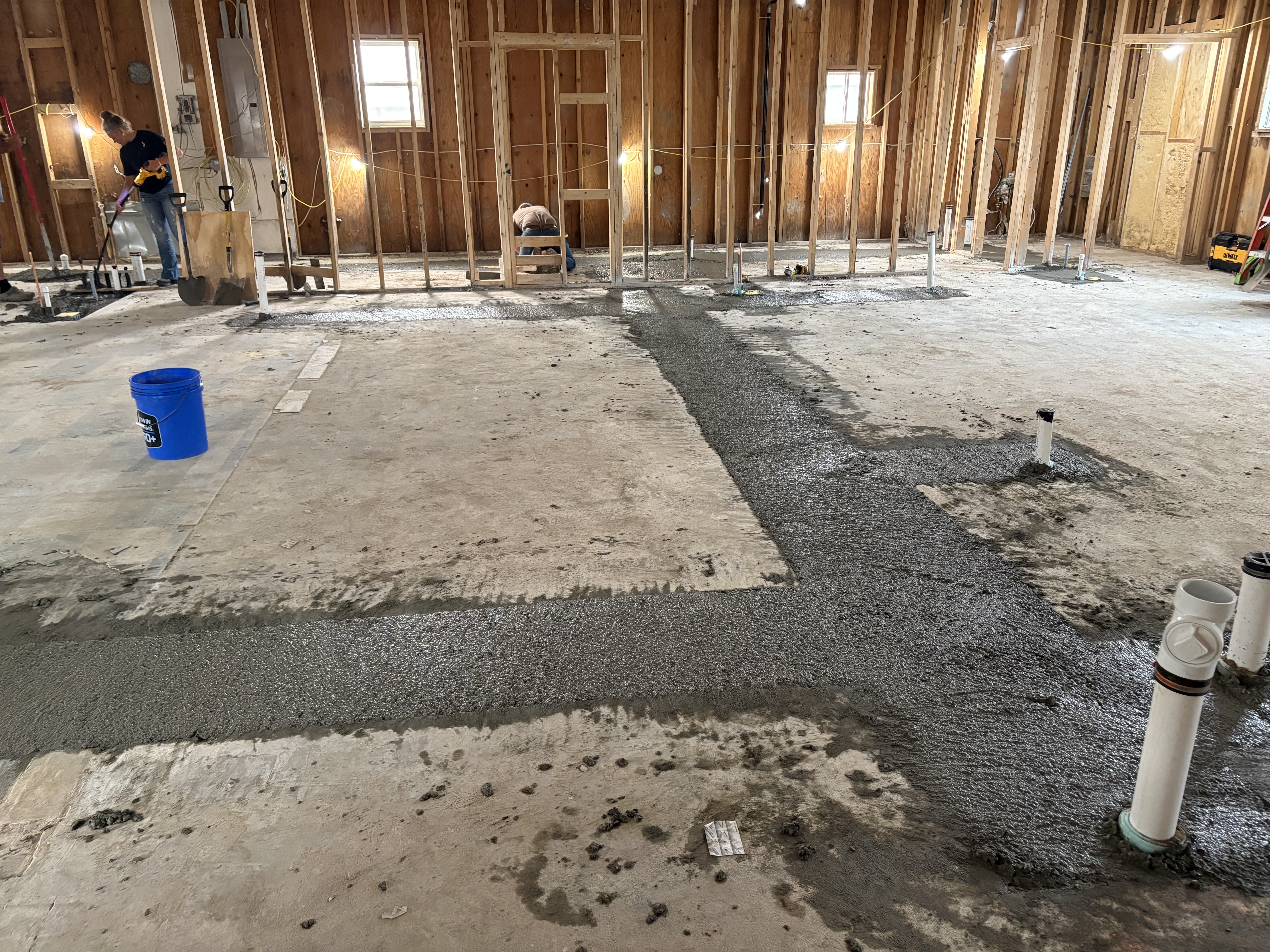 Plumbing and drains were finalized and concrete poured back to the subfloor